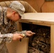 Soldier Performs Routine Maintenance on Power Supply in Iraq