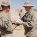 Army Officer Presents Combat Spur to Air Force Counterpart in Iraq
