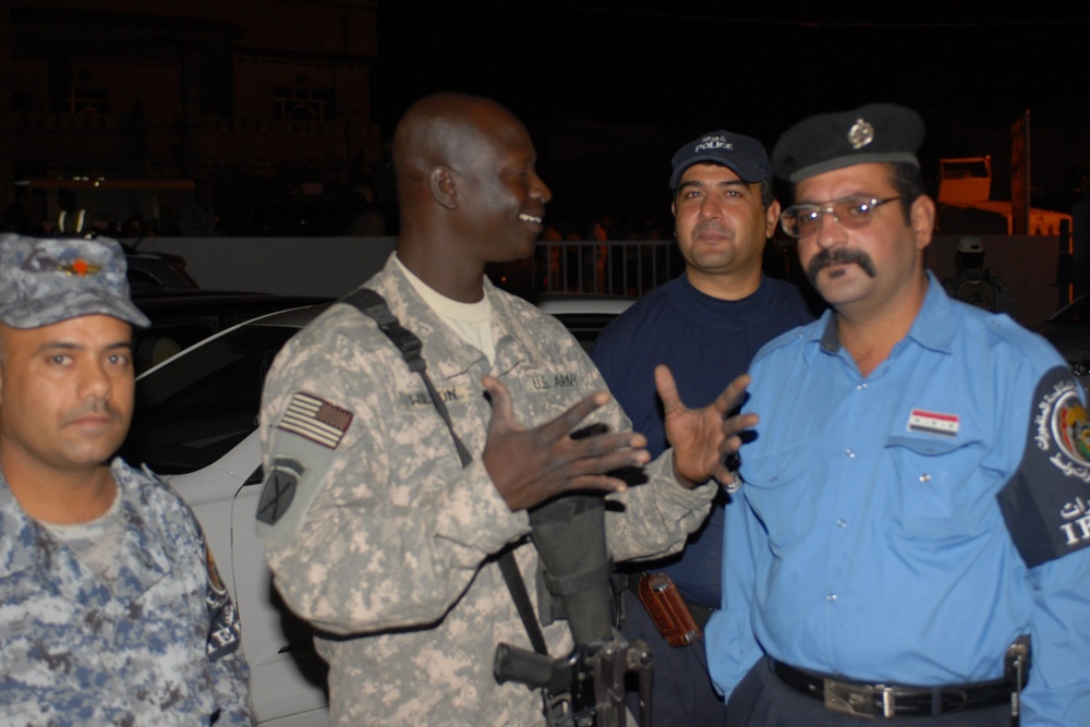 U.S. Army Translator Speaks with Iraqi Policeman in Kut