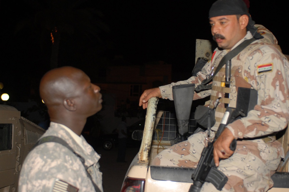 U.S. Army Translator Speaks with Iraqi Soldier in Kut