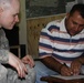 U.S. Army Officer Pays Local Contractor for School Improvements in Iraq