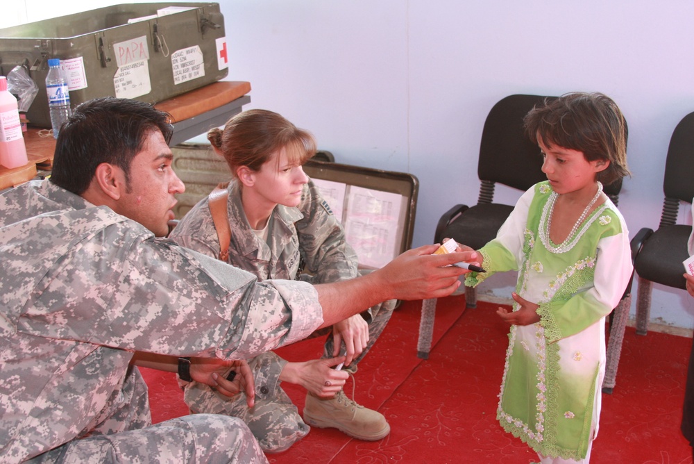 Air Force Medic Provides Care to Afghan Girl During Medical Engagement