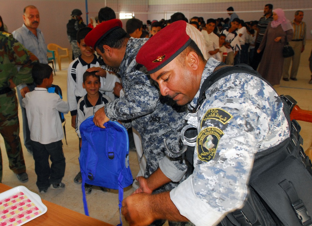 Iraqi Police Distribute School Supplies to Children in Baghdad