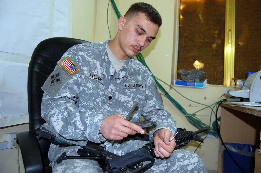 Army Clerk Maintains Rifle at Camp Taji in Iraq
