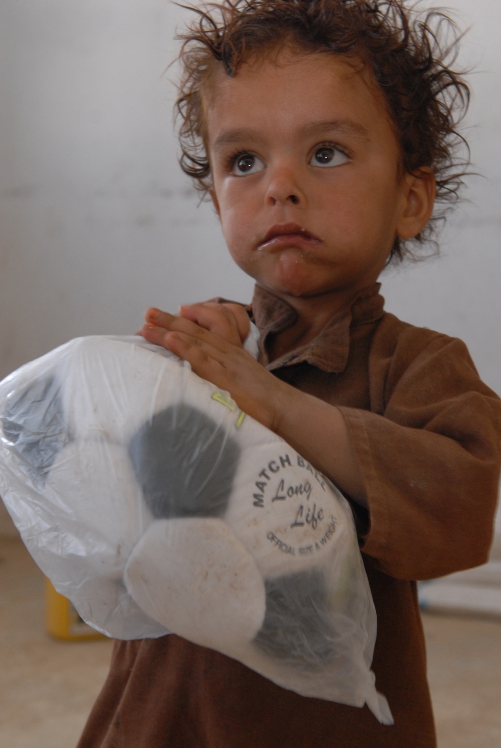 Afghan Boy Receives Soccer Ball from U.S. Forces in Kandahar