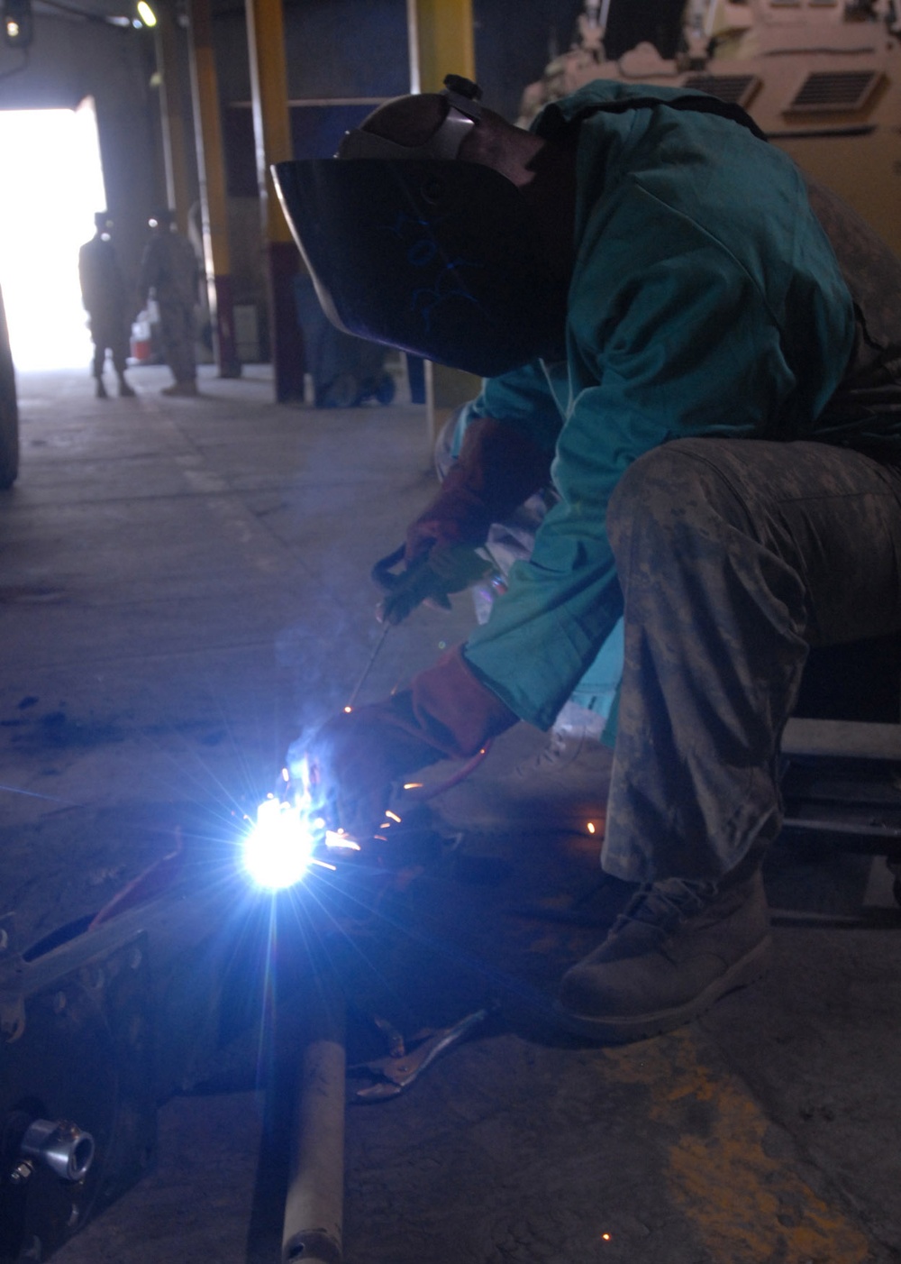 Soldier Welds Trailer Support at Forward Operating Base in Baghdad