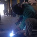 Soldier Welds Trailer Support at Forward Operating Base in Baghdad