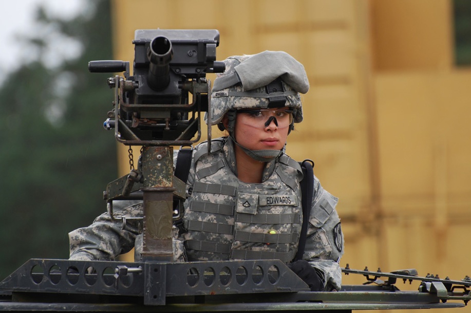 Military Police Soldier Stands Guard with Grenade Launcher