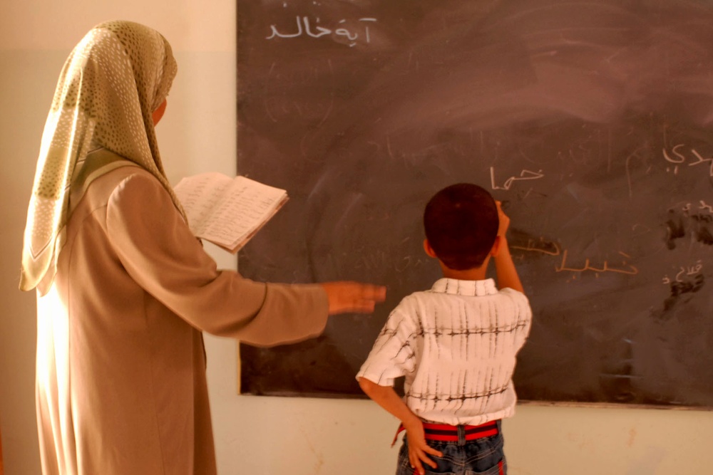 Iraqi Boy Writes on Blackboard in Sadr City School