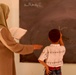 Iraqi Boy Writes on Blackboard in Sadr City School