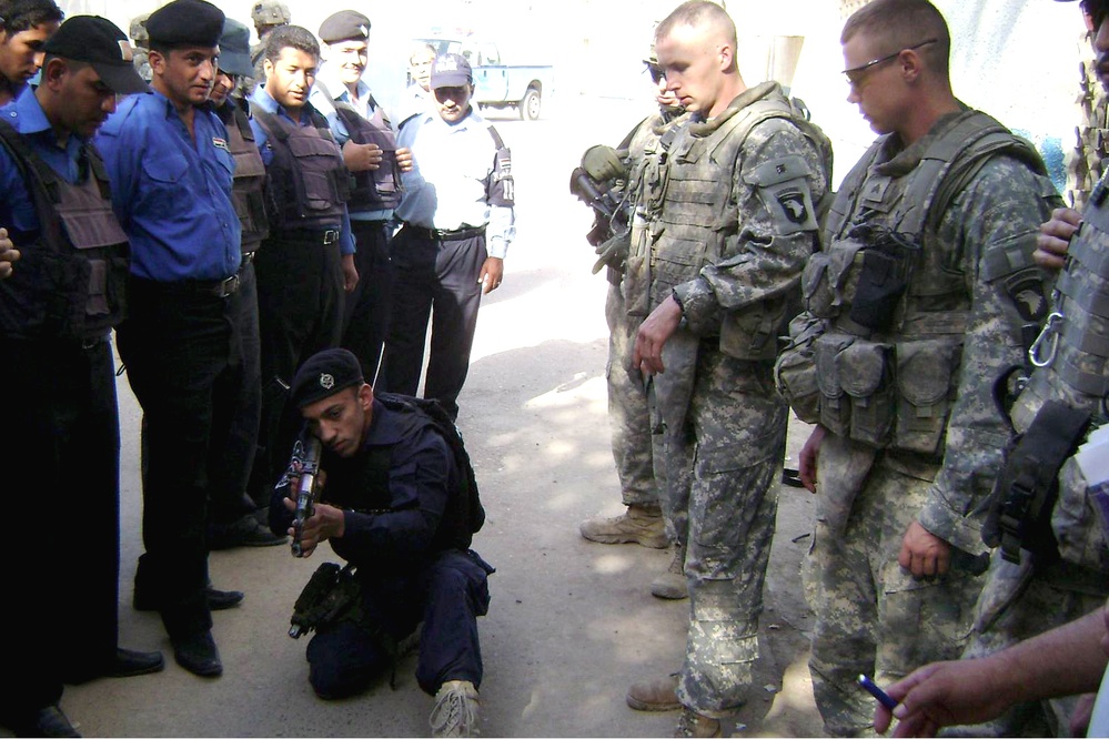 U.S. Soldiers Observe Iraqi Police Officer's Firearms Training in Baghdad