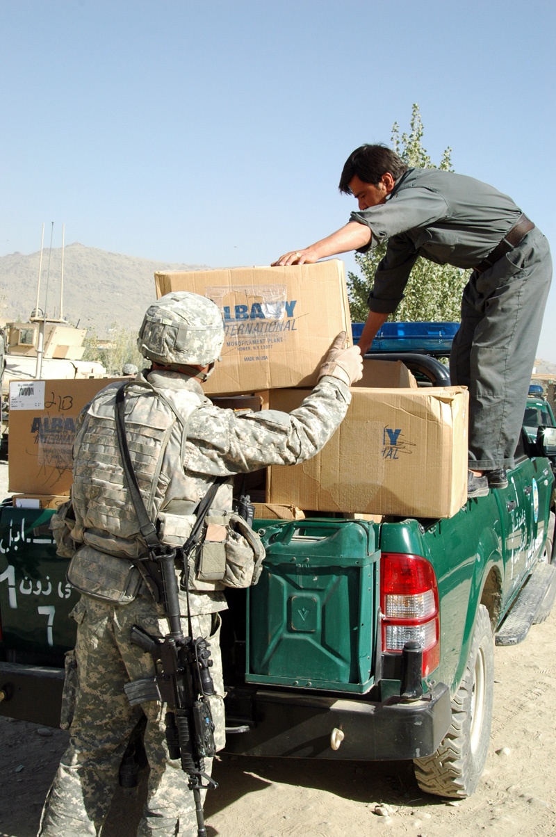 U.S. Troops and Afghan Police Distribute Donated Supplies to Local School
