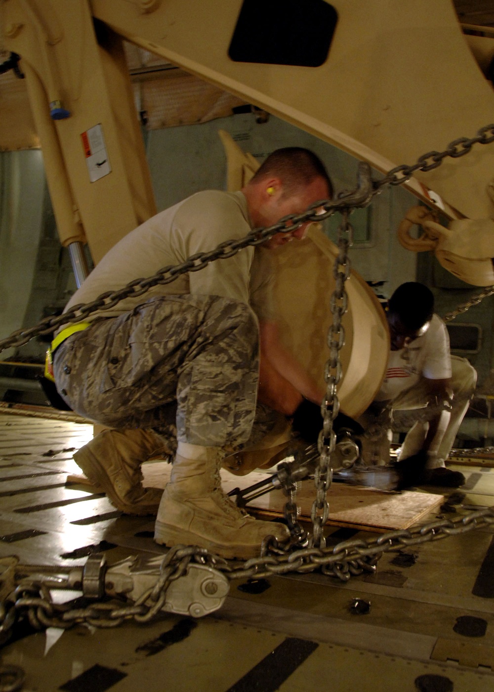 Airman Secures Army Excavator for Air Transport