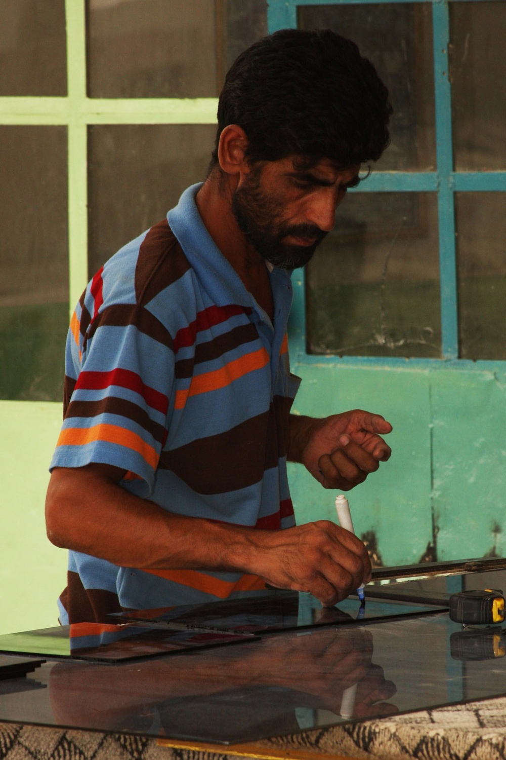 Glass Cutter Prepares Sheet for Agricultural Bank in Tarmiyah