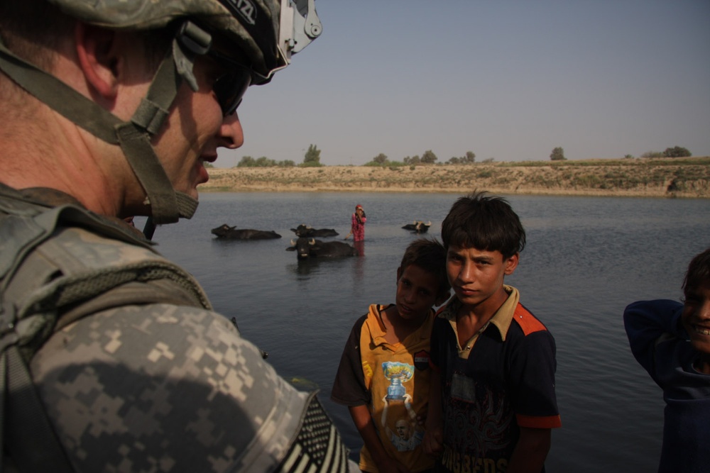 Army Captain Engages with Iraqi Children Near Diyala River