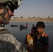 Army Captain Engages with Iraqi Children Near Diyala River