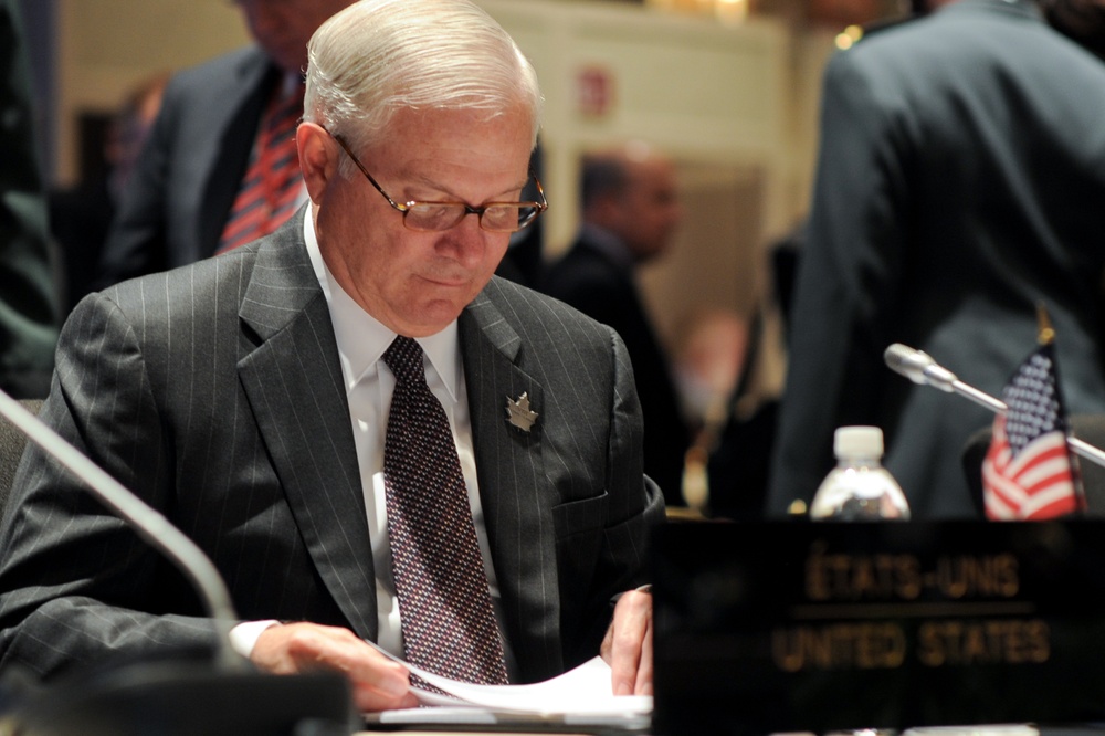 Defense Secretary Gates Reviews Notes at Defense Ministers Conference