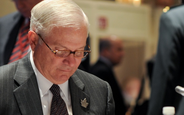 Defense Secretary Gates Reviews Notes at Defense Ministers Conference