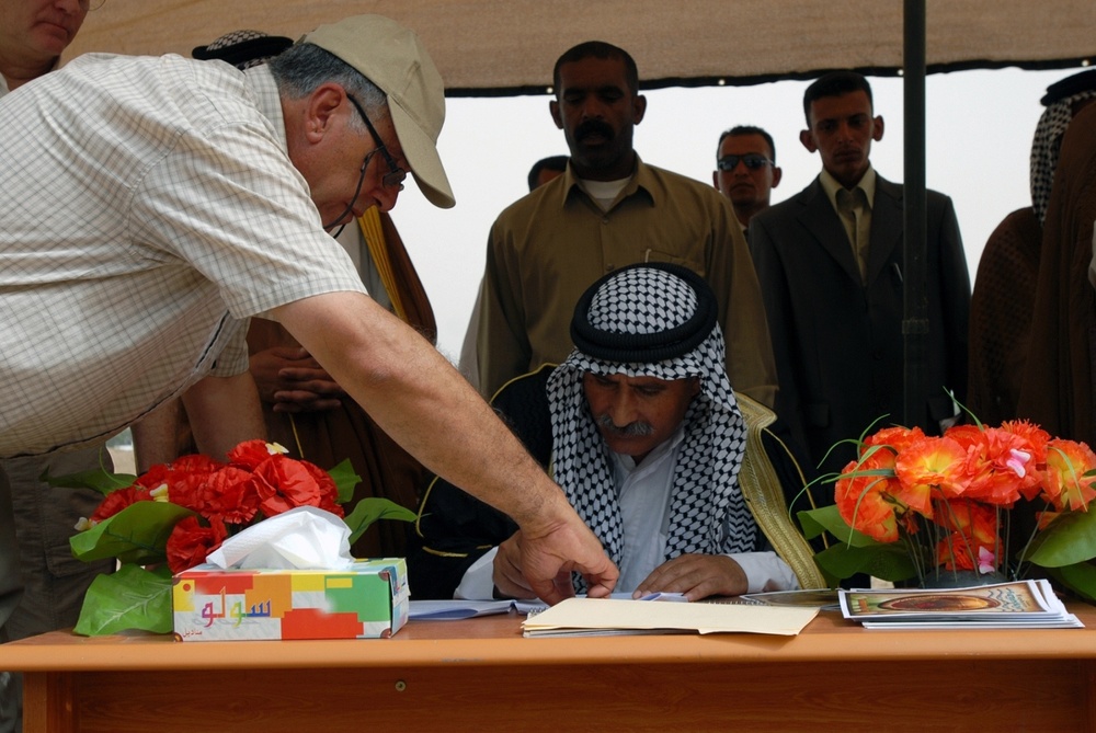 Iraqi Farmer Leader Signs Document for Time Capsule at New Agricultural Center