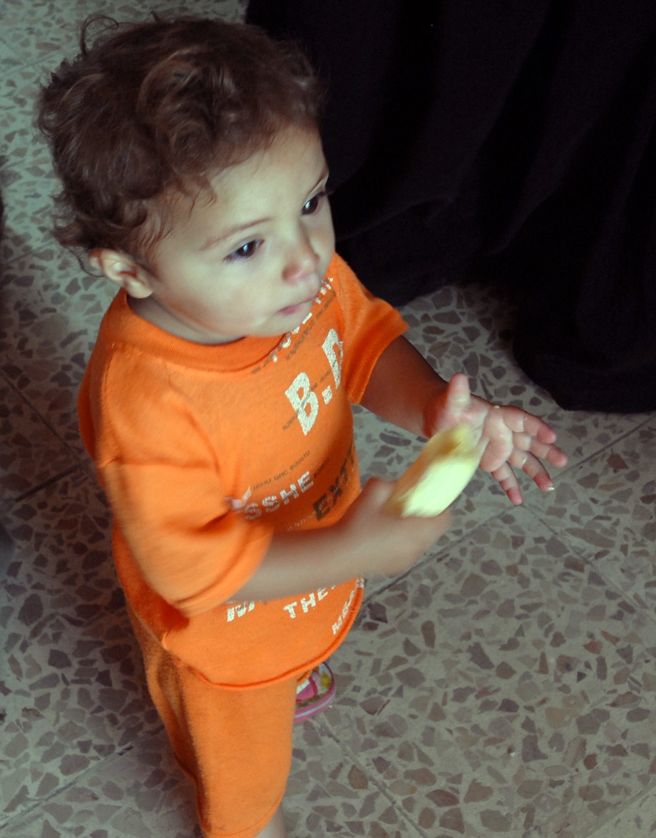 Iraqi Toddler Enjoys Banana During Medical Checkup