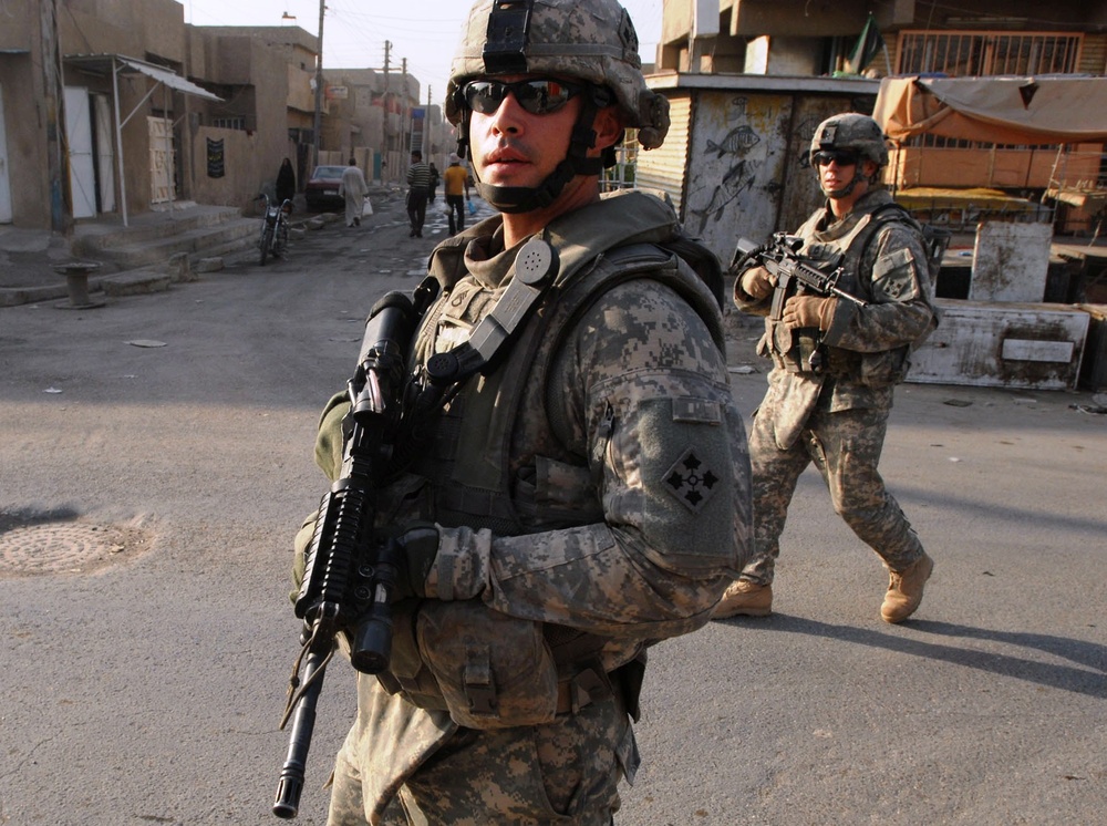 U.S. Soldiers Conduct Early-Morning Patrol in Baghdad Market