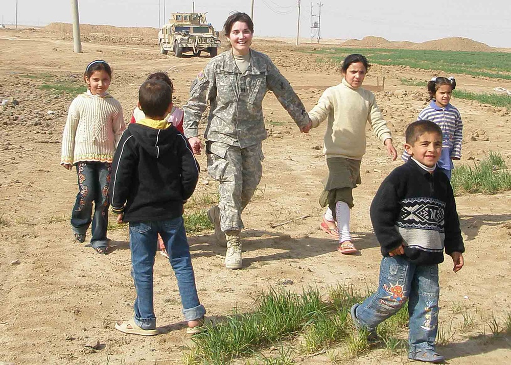 U.S. Army Captain Engages with Iraqi Children on Provincial Farm