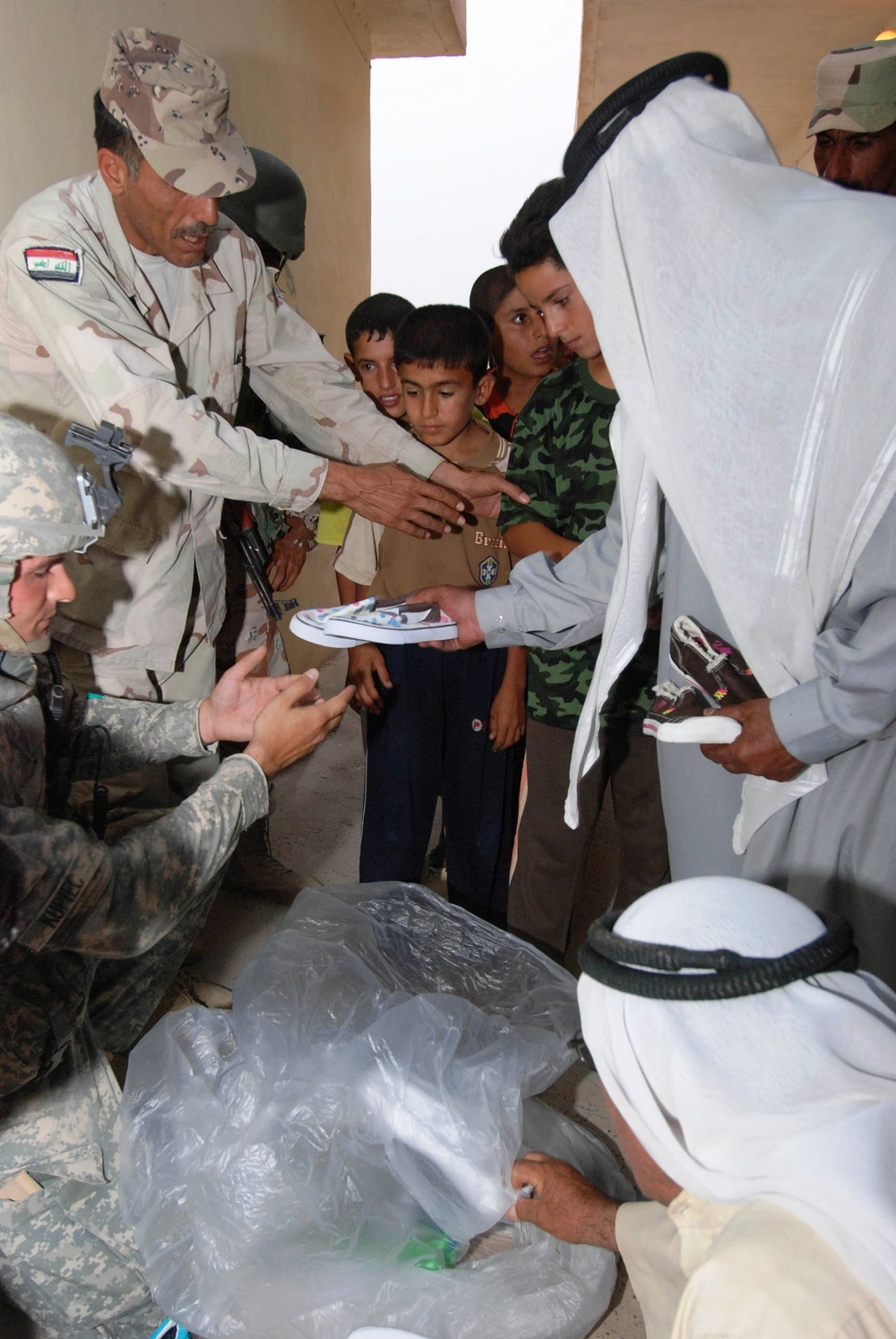 Soldiers Distribute Shoes to Children in Iraqi Village During Operation Summit Pursuit