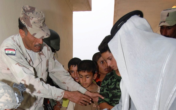 Soldiers Distribute Shoes to Children in Iraqi Village During Operation Summit Pursuit