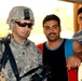 Army Staff Sgt. Interacts with Iraqi Civilians During Household Assessment
