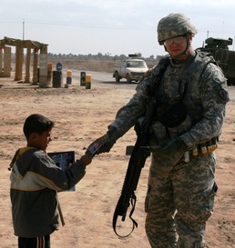 U.S. Soldier Connects with Iraqi Child During Patrol