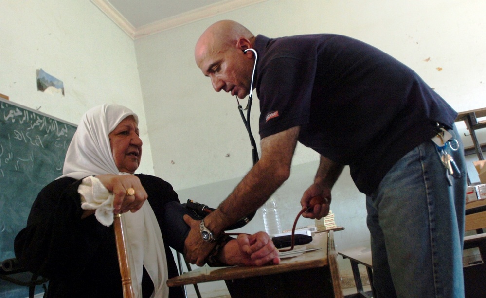 Iraqi Physician Checks Woman's Blood Pressure in Baghdad