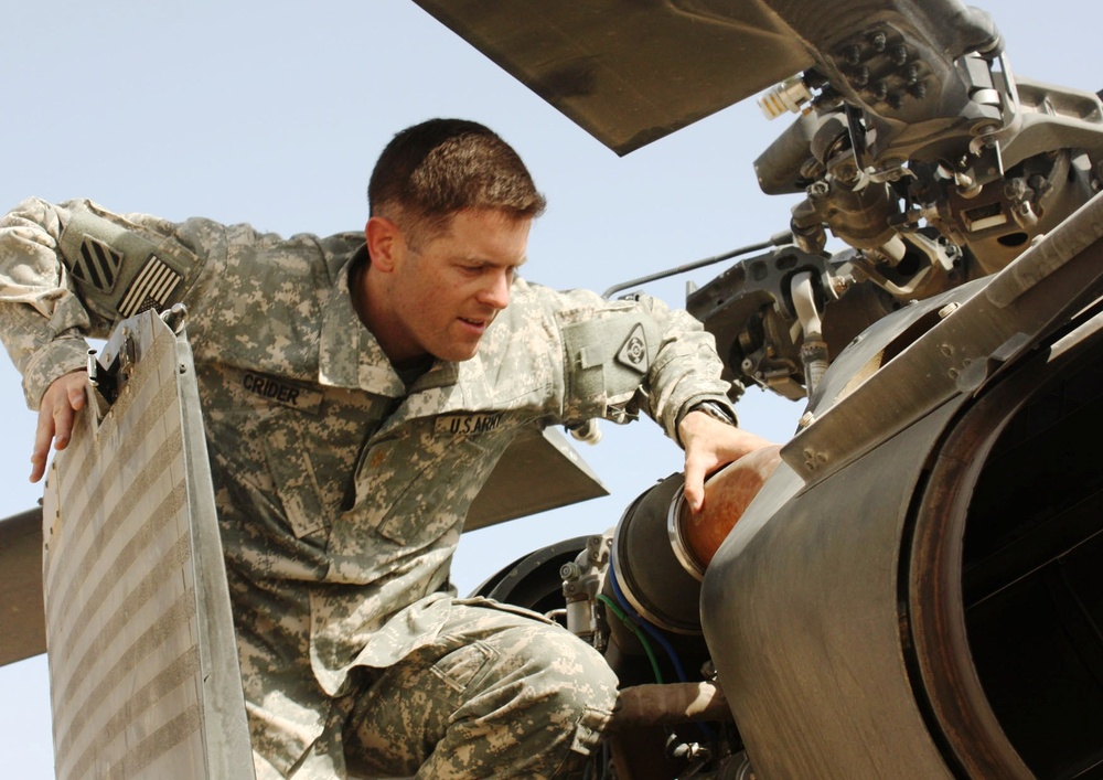 Army Major Performs Pre-Flight Check on Black Hawk Medevac Helicopter in Iraq