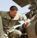 Army Major Performs Pre-Flight Check on Black Hawk Medevac Helicopter in Iraq
