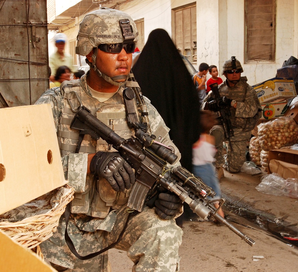 Soldier Provides Security During Market Patrol in Iraq