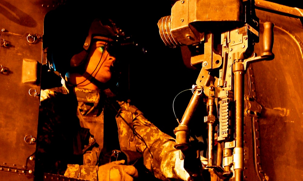 Army Sgt. Mans Gunner's Seat of Black Hawk Helicopter Before Mission in Iraq