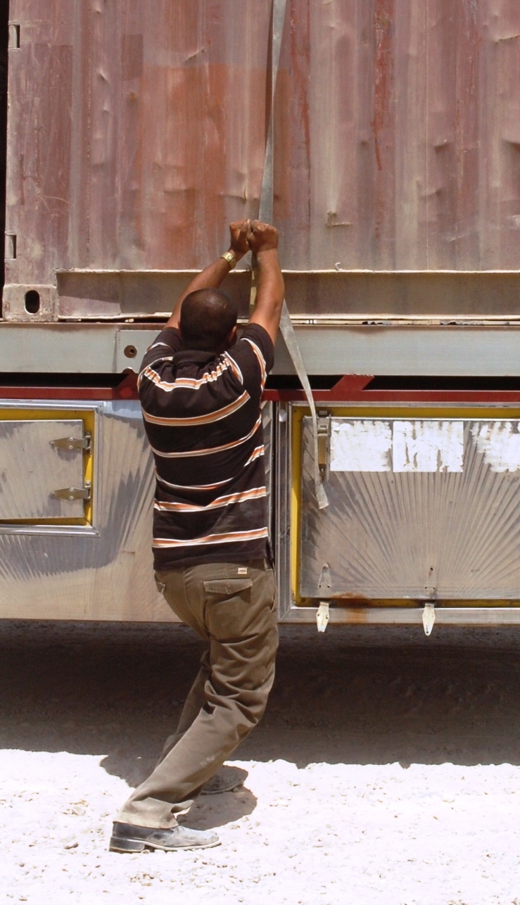 Iraqi Logistics Network Driver Secures Load at Camp Liberty