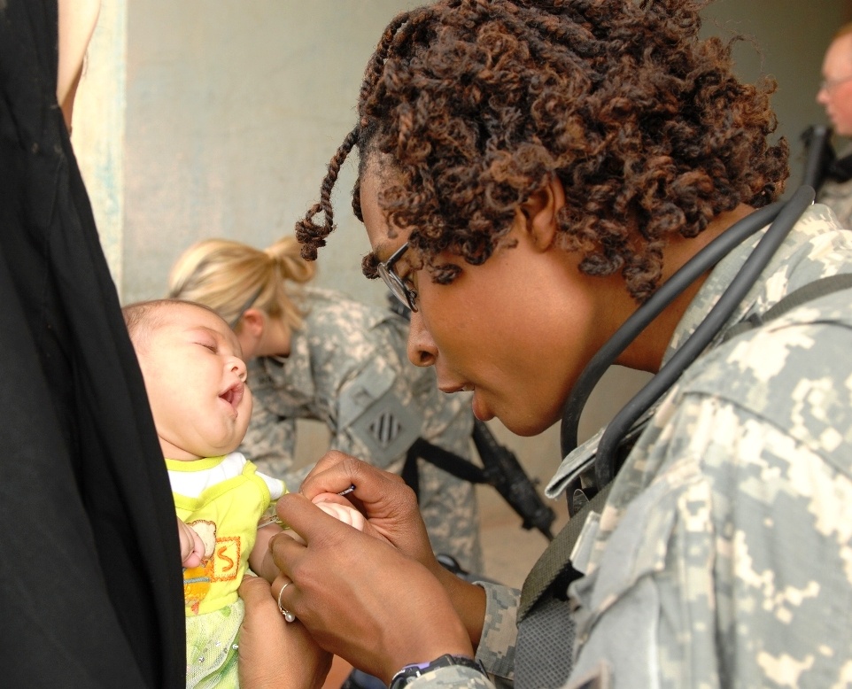 U.S. Army Medic Provides Care to Iraqi Girl During Medical Engagement