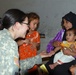 Army Medic Comforts Iraqi Child During Medical Engagement