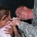 Army Medic Examines Child's Mouth During Medical Engagement