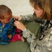 U.S. Navy Officer Provides Medical Care to Afghan Child During Outreach Event