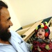 Afghan Father Shares Joyful Moment with Son at Medical Outreach Event