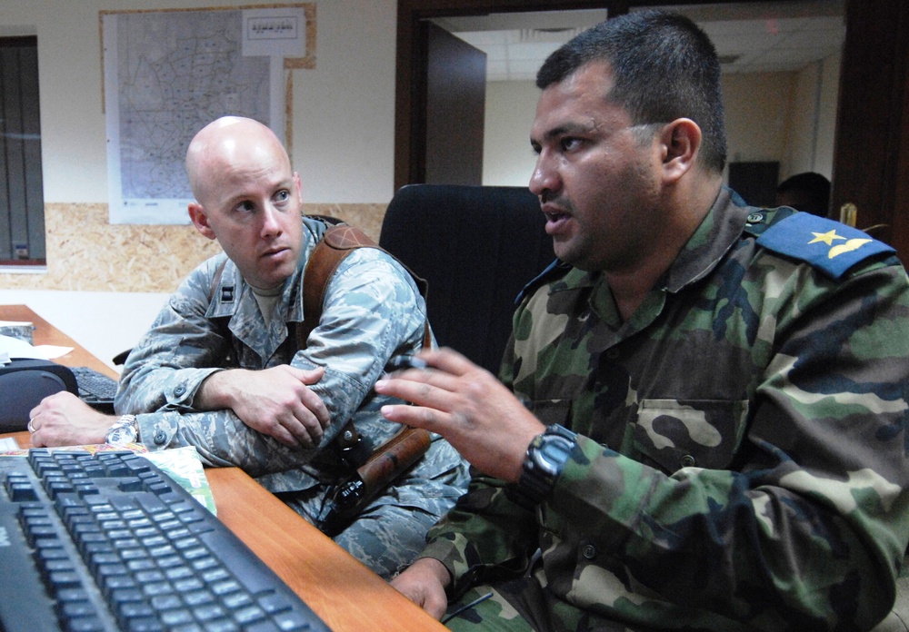 U.S. Air Force Officer Advises Iraqi Counterpart on Air Operations Center Logistics