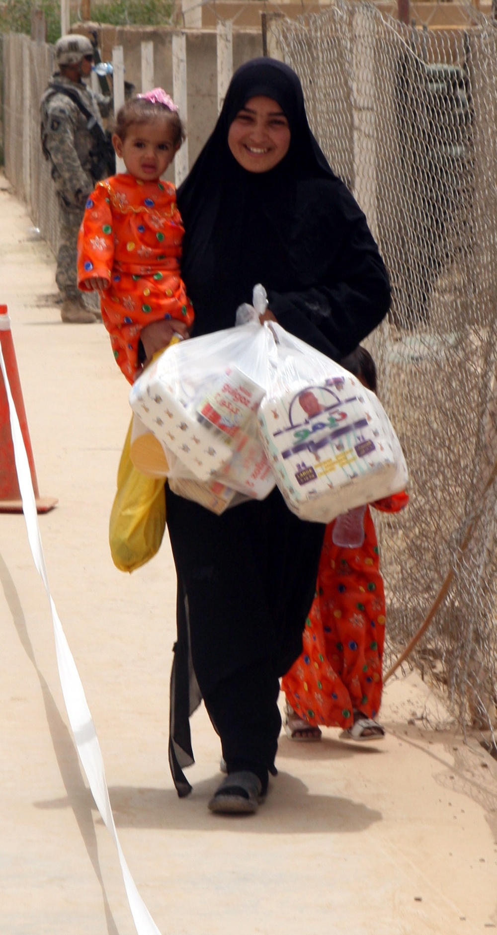Iraqi Family Receives Aid at Radwaniyah Palace Complex