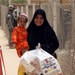 Iraqi Family Receives Aid at Radwaniyah Palace Complex