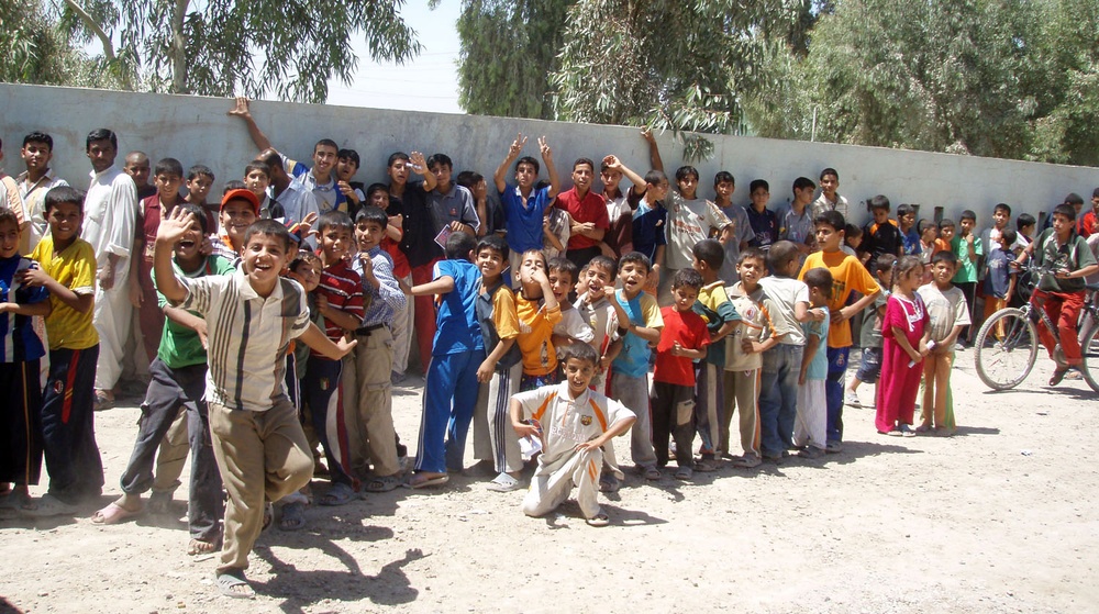 Iraqi, U.S. Troops Distribute Aid to Eager Children in Dehna Village
