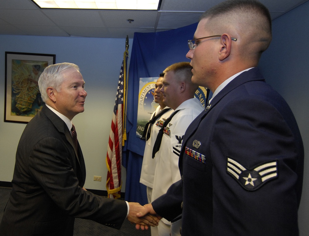 Defense Secretary Gates Administers Oath of Re-enlistment to Airman, Sailors in Guam