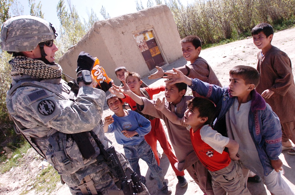 Army Sergeant Distributes Candy to Afghan Children