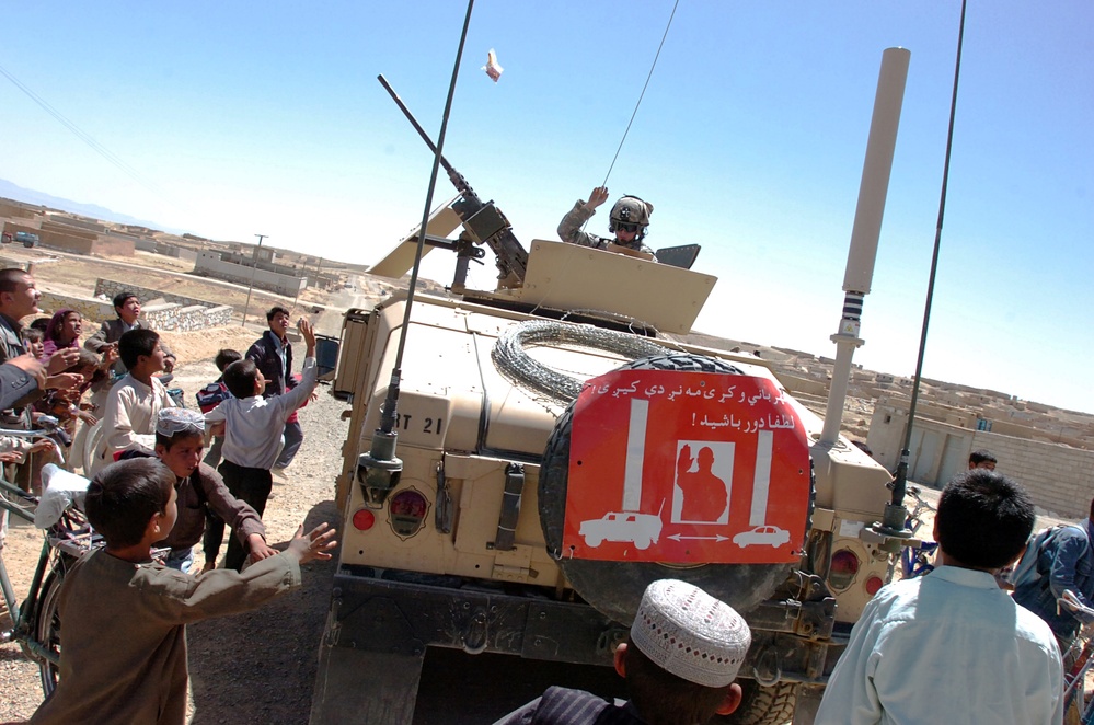 Soldier Distributes Treats to Afghans in Ghazni Province