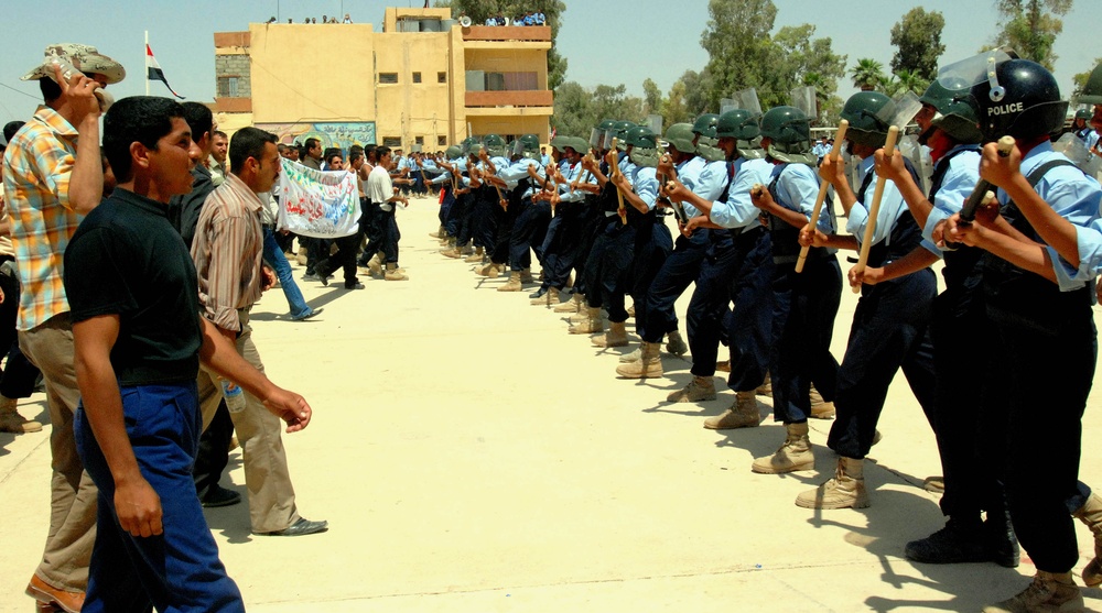 Iraqi Police Recruits Demonstrate Riot Control at Graduation Ceremony