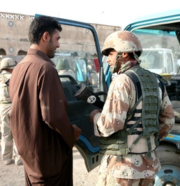 Iraqi Soldier Engages Local Shopkeeper in Basra Neighborhood